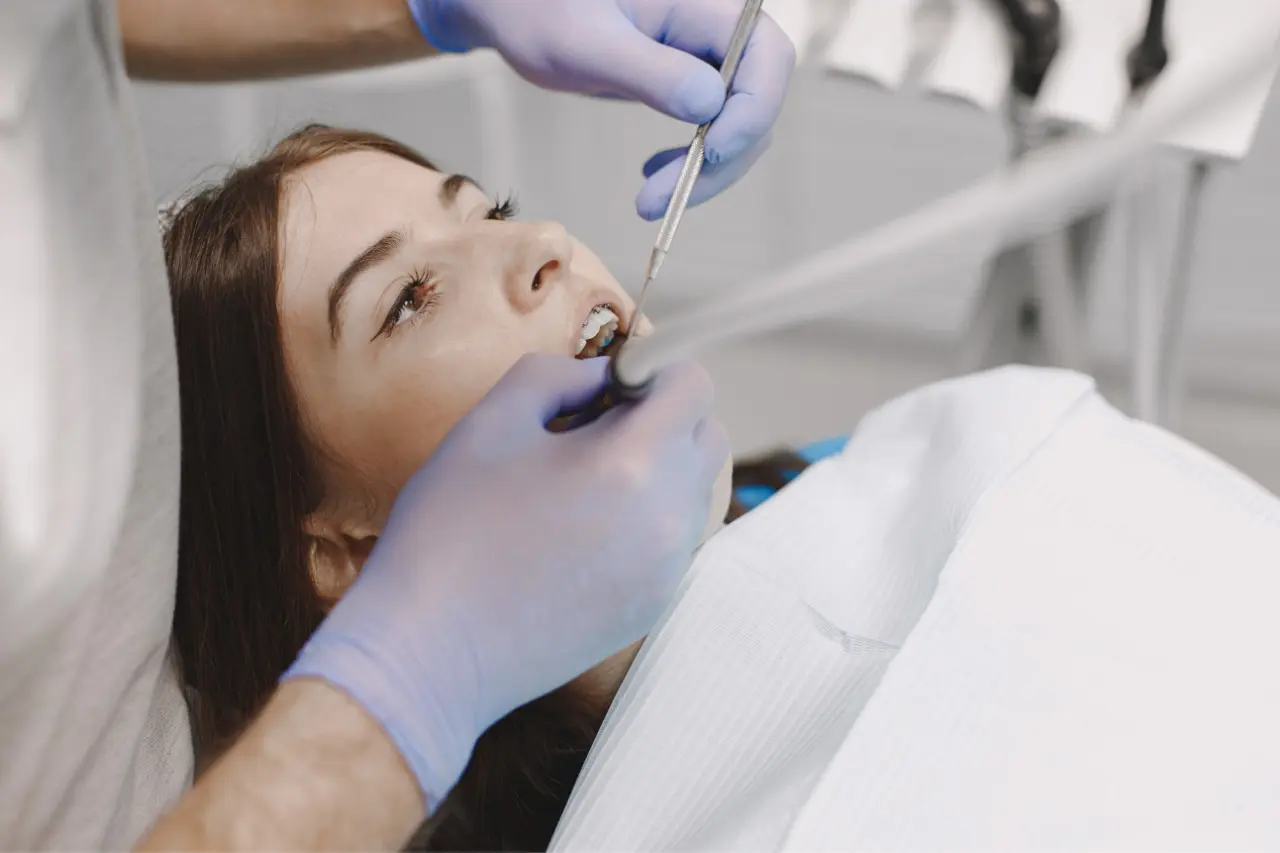 a girl receiving scaling treatment at a dental