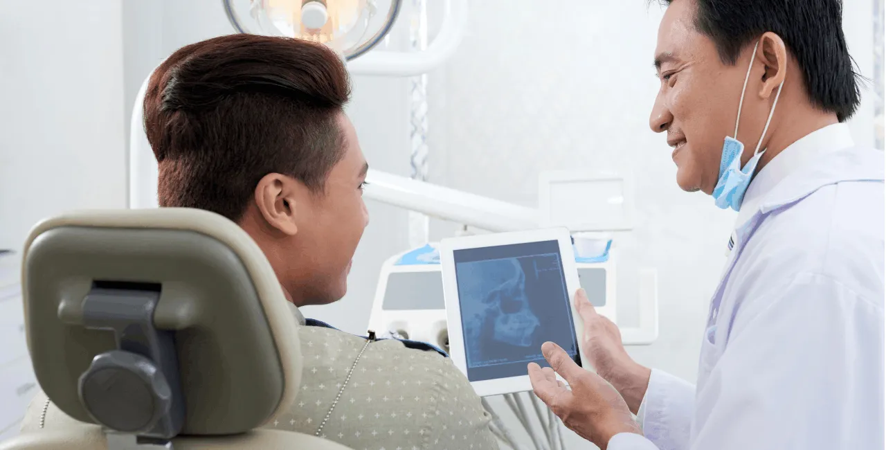 man looking at dental xray