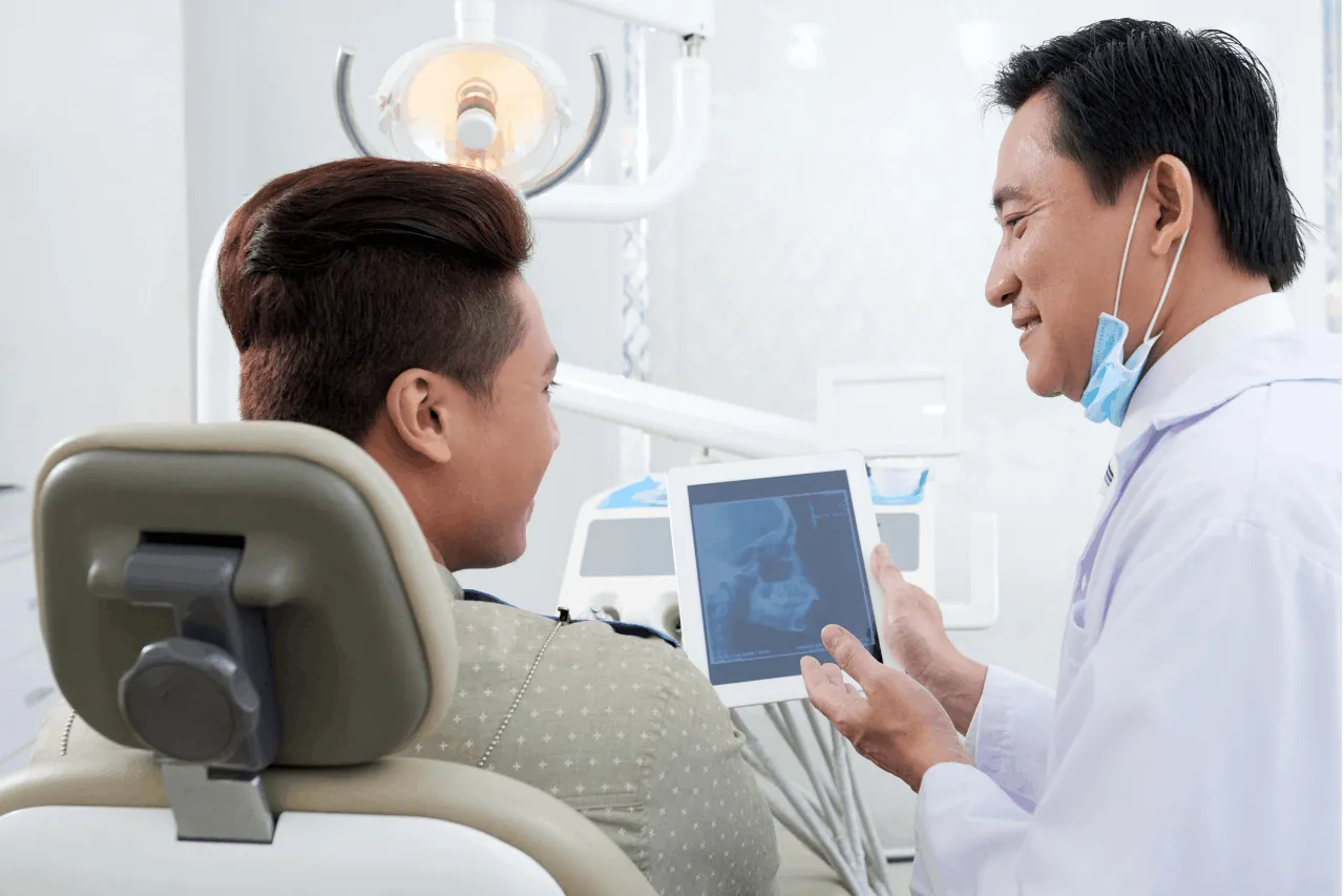 man looking at dental xray