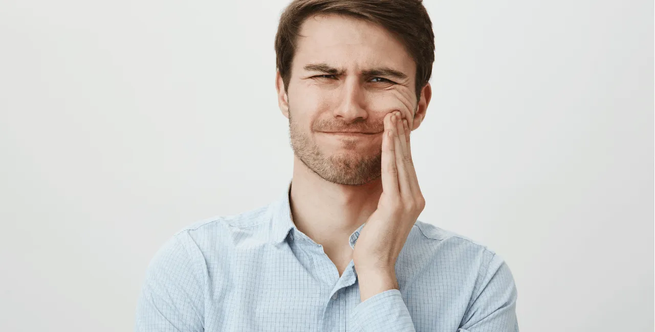 man with wisdom tooth pain