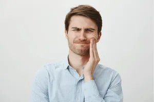 man with wisdom tooth pain