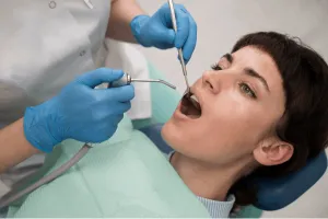 woman scaling her teeth
